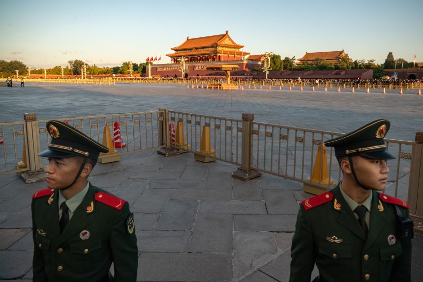 People's Liberation Army soldiers stand guard in Tiananmen Square at the end of the flag raising ceremony as China marks the 75th anniversary of the founding of the Peoples Republic, in Beijing, China, on Tuesday, October 1, 2024.