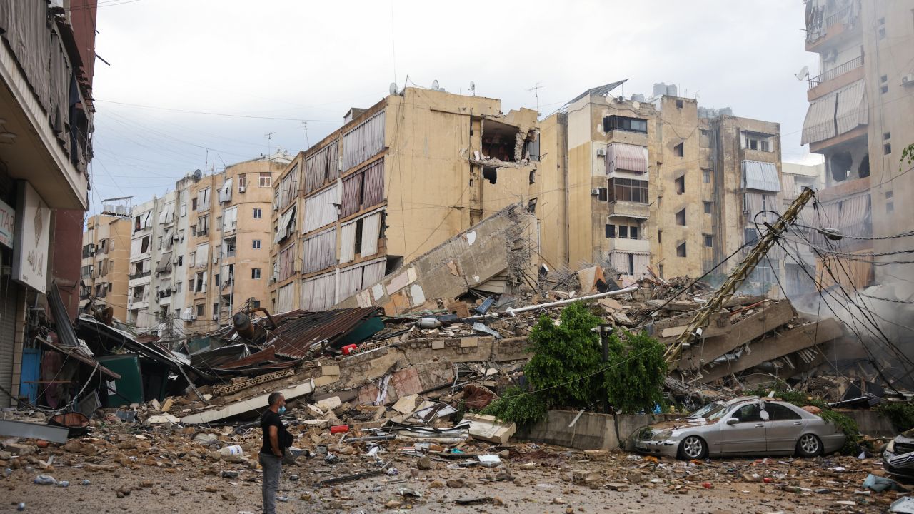 A man looks at the destruction at the site of an overnight Israeli airstrike in the Bir el-Abed neighborhood of Beirut's suburbs on Tuesday.