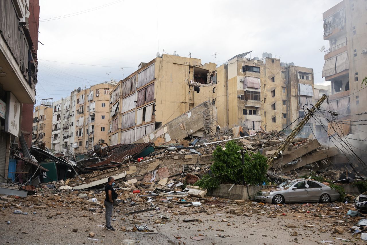 A man looks at the destruction at the site of an overnight Israeli airstrike in the Bir el-Abed neighborhood of Beirut's suburbs on Tuesday.