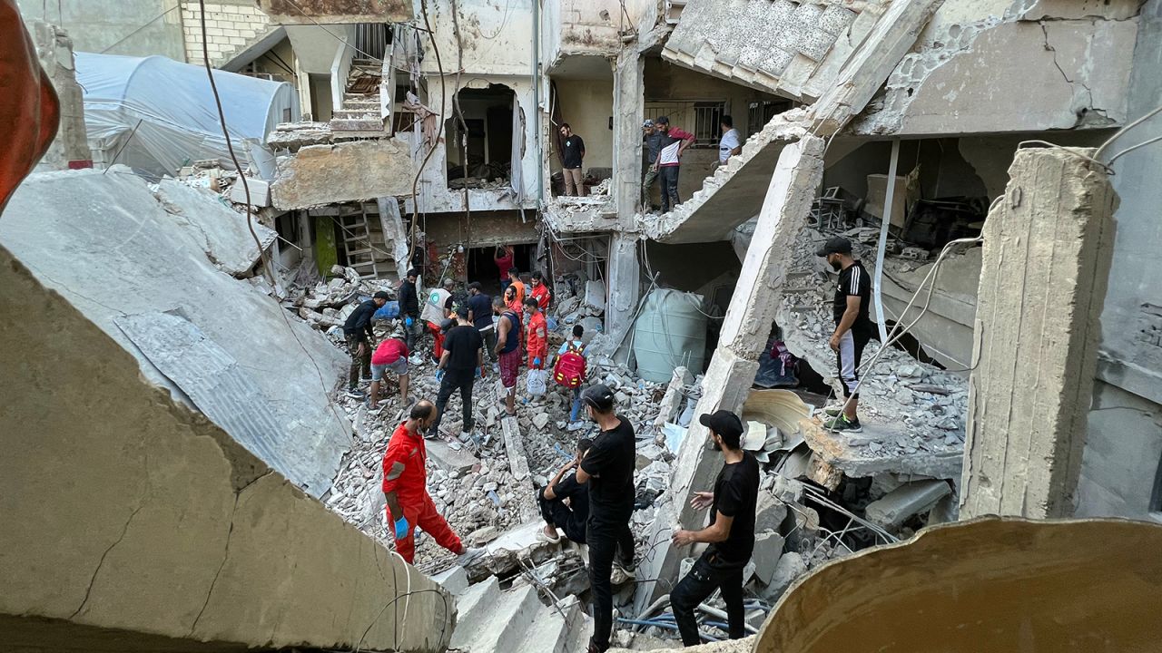 Residents and rescue teams inspect the damage following an overnight Israeli airstrike on the Ain al-Helweh camp for Palestinian refugees on the outskirts of the southern port city of Sidon early on October 1.