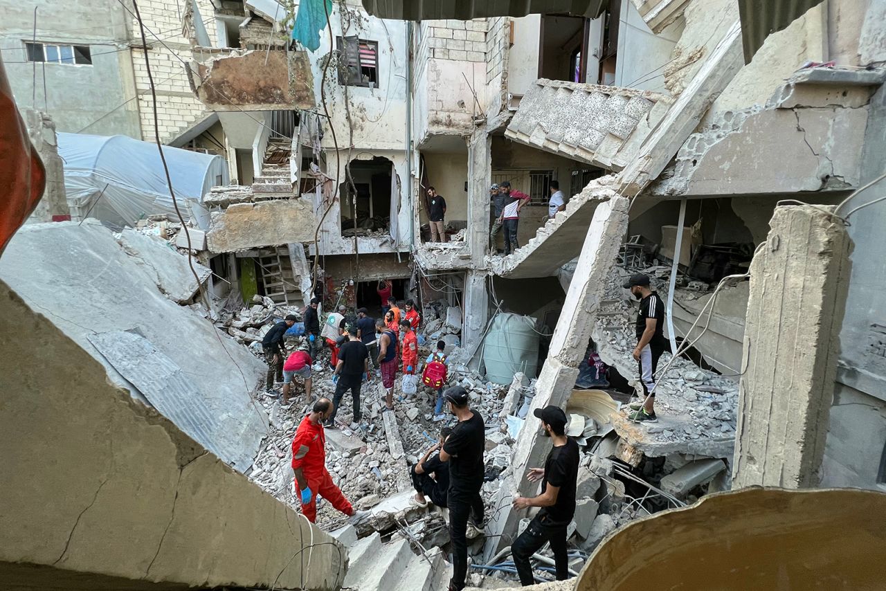 Residents and rescue teams inspect the damage following an overnight Israeli airstrike on the Ain al-Helweh camp for Palestinian refugees on the outskirts of the southern port city of Sidon early on October 1.