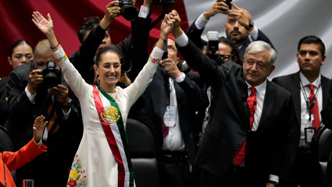 Mexico's new President Claudia Sheinbaum (L) and outgoing Mexican President Andres Manuel Lopez Obrador wave to the attendees during the inauguration ceremony at the Congress of the Union in Mexico City on October 1, 2024. (Photo by Alfredo ESTRELLA / AFP) (Photo by ALFREDO ESTRELLA/AFP via Getty Images)