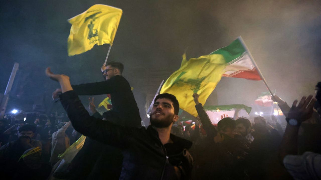 Demonstrators celebrate during a rally outside the British Embassy in Tehran on October 1, 2024, after Iran fired a barrage of missiles into Israel in response to the killing of Hezbollah leader Hassan Nasrallah and other Iranian-backed militias. Reports indicate that Iran fired between 150 and 200 missiles at Tehran. This is the country's second attack on Israel after a missile and drone attack in April in response to a deadly Israeli airstrike on the Iranian consulate in Damascus. (Photo by ATTA KENARE / AFP) (Photo by ATTA KENARE/AFP via Getty Images)