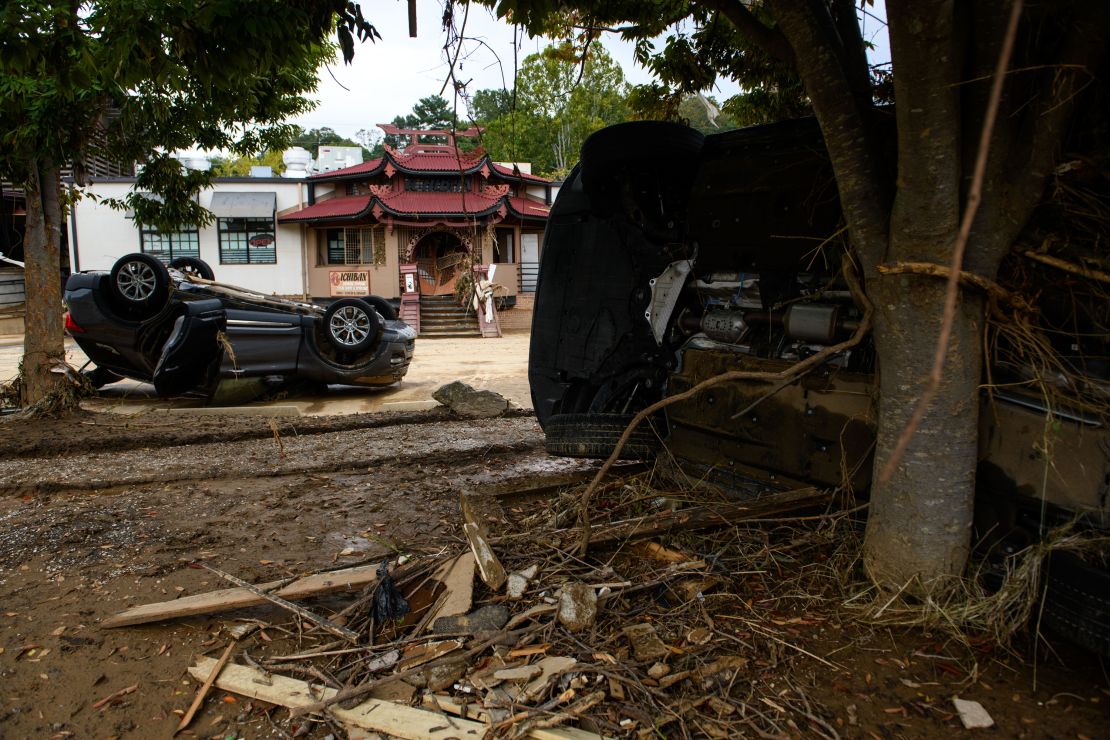 Flood-damaged cars are strewn about Biltmore Village across from the Biltmore Estate in Asheville in the aftermath of Hurricane Helene on October 1.