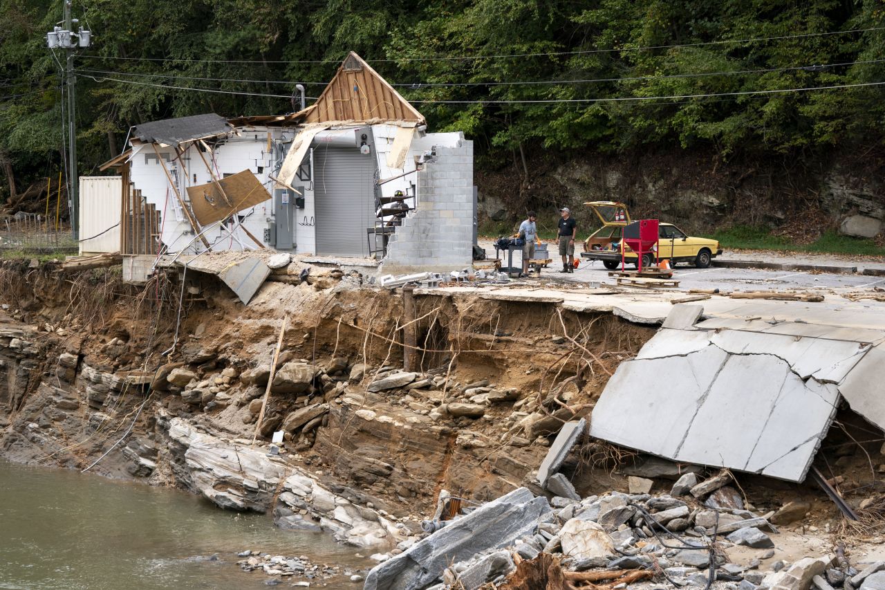 BAT CAVE, NORTH CAROLINA - OCTOBER 1: Avery Sherrill, left, and Atticus Sherrill, brothers, and their father Michael Sherrill salvage what they can from their destroyed business, Mudtools, along the Broad River in the aftermath of Hurricane Helene on October 1, 2024 in Bat Cave, North Carolina. The death toll has topped 140 people across the southeastern U.S. due to the storm, according to published reports, which made landfall as a category 4 storm on Thursday. Millions are without power and the federal government has declared major disasters in areas of North Carolina, Florida, South Carolina, Tennessee, Georgia, Virginia and Alabama, freeing up federal emergency management money and resources for those states, according to the reports. (Photo by Sean Rayford/Getty Images)