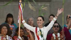 Mexico's new President Claudia Sheinbaum waves after receiving a ceremonial staff from indigenous peoples at the Zocalo Square in Mexico City on October 1, 2024. (Photo by CARL DE SOUZA / AFP) (Photo by CARL DE SOUZA/AFP via Getty Images)