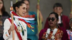 Mexico's new President Claudia Sheinbaum (L) reacts after receiving a ceremonial staff from indigenous peoples at the Zocalo Square in Mexico City on October 1, 2024. (Photo by CARL DE SOUZA / AFP) (Photo by CARL DE SOUZA/AFP via Getty Images)