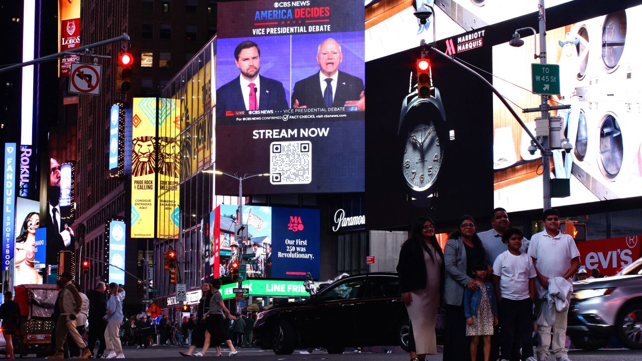 A debate between Sen. JD Vance and Minnesota Gov. Tim Walz is seen in Times Square in New York on October 1.