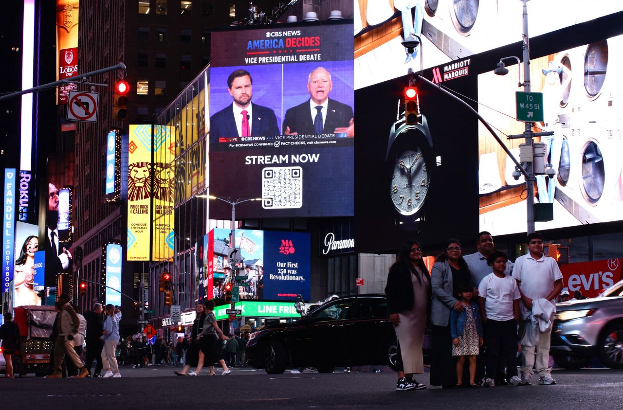 A screen displays the CBS vice presidential debate between Sen. JD Vance and Minnesota Gov. Tim Walz in Times Square in New York on October 1.