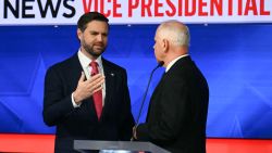 US Senator and Republican vice presidential candidate J.D. Vance (L) and Minnesota Governor and Democratic vice presidential candidate Tim Walz talk with each other at the end of the Vice Presidential debate hosted by CBS News at the CBS Broadcast Center in New York City on October 1, 2024. (Photo by ANGELA WEISS / AFP) (Photo by ANGELA WEISS/AFP via Getty Images)