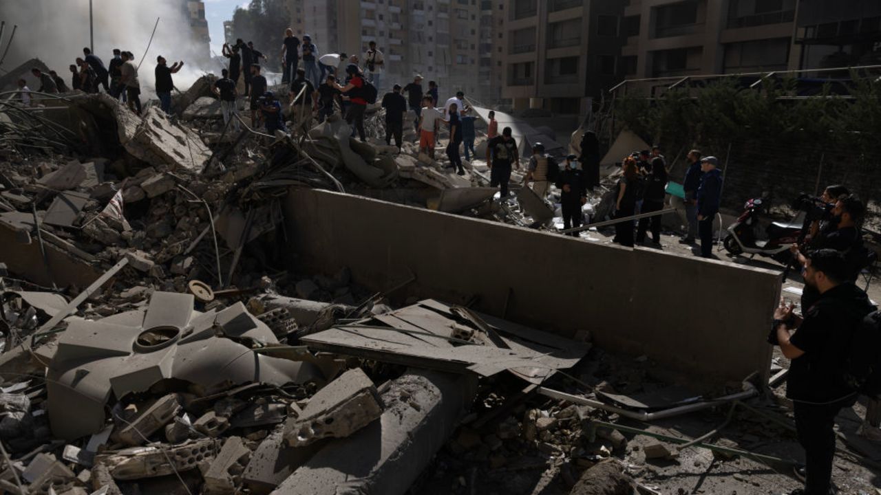 BEIRUT, LEBANON - OCTOBER 2: Smoke rises from a building destroyed by an Israeli airstrike as journalists and local residents visit during a press tour on October 2, 2024 in Beirut, Lebanon. Israel continued airstrikes on Beirut and its southern suburbs as its military announced a ground offensive in Lebanon, part of what it said would be a "limited" incursion to target Hezbollah forces. (Photo by Daniel Carde/Getty Images)