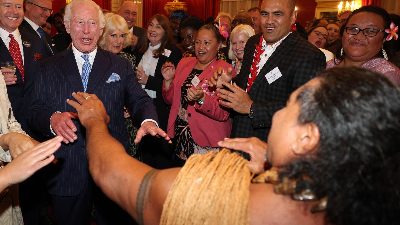 Britain's King Charles III reacts as former Samoan rugby player Freddie Tuilagi dances during a reception to celebrate the Commonwealth Diaspora of the United Kingdom, ahead of the Commonwealth Heads of Government Meeting in Samoa, at St. James's Palace, in London on October 2, 2024. (Photo by Adrian Dennis / POOL / AFP) (Photo by ADRIAN DENNIS/POOL/AFP via Getty Images)