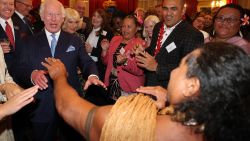 Britain's King Charles III reacts as former Samoan rugby player Freddie Tuilagi dances during a reception to celebrate the Commonwealth Diaspora of the United Kingdom, ahead of the Commonwealth Heads of Government Meeting in Samoa, at St. James's Palace, in London on October 2, 2024. (Photo by Adrian Dennis / POOL / AFP) (Photo by ADRIAN DENNIS/POOL/AFP via Getty Images)