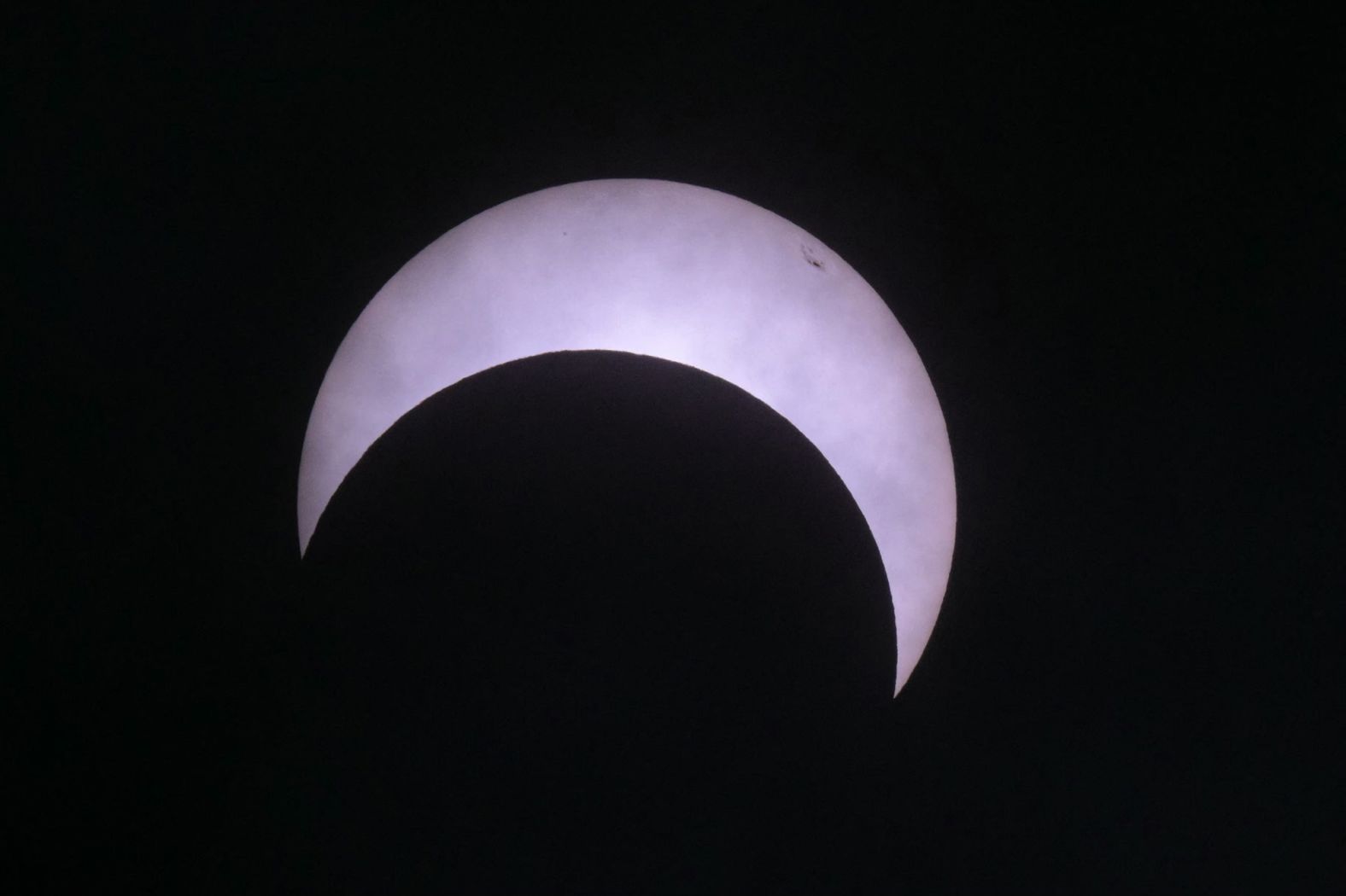 The moon makes its way in front of the sun over Puerto San Julián, Argentina.