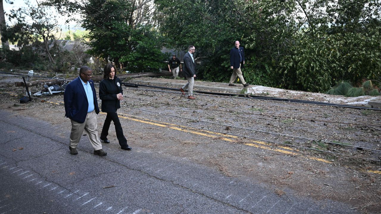 Vice President Kamala Harris walks with Augusta Mayor Garnett Johnson as they survey the damage from Hurricane Helene, in Augusta, Georgia, on October 2.