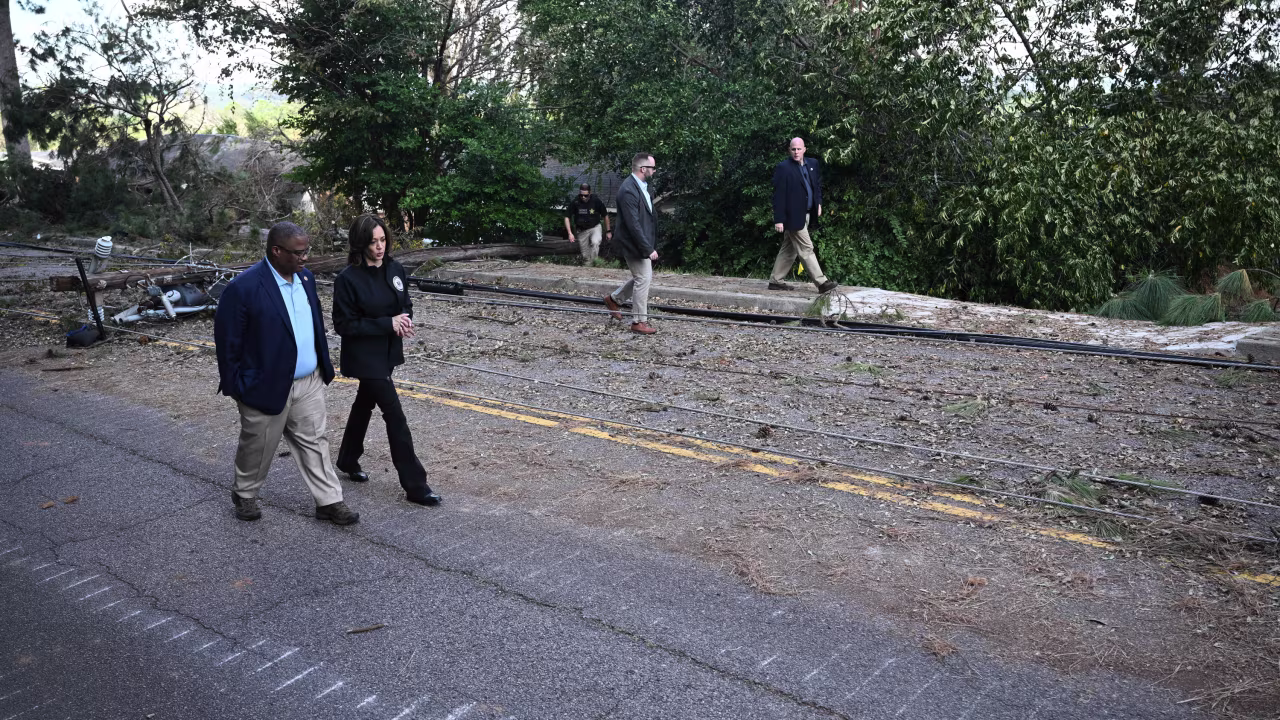 Vice President Kamala Harris walks with Augusta Mayor Garnett Johnson as they survey the damage from Hurricane Helene, in Augusta, Georgia, on October 2.