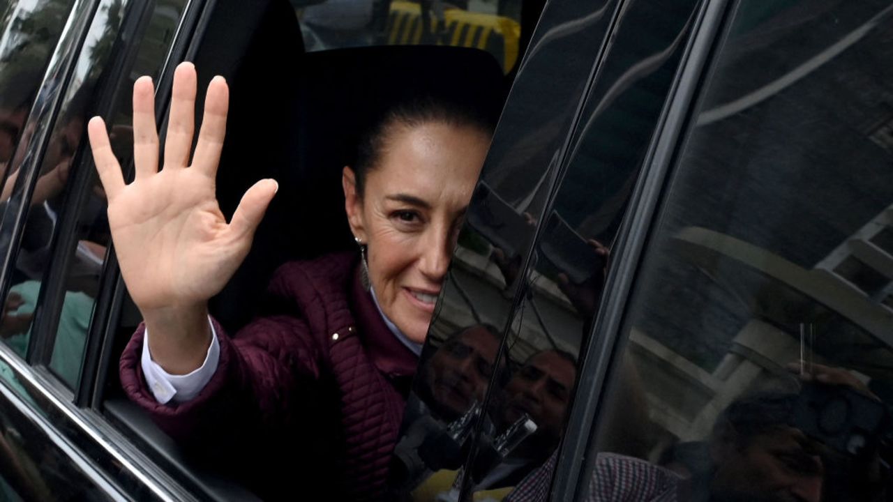 Mexican President Claudia Sheinbaum greets supporters after arriving to evaluate the situation following Hurricane John in Acapulco, Guerrero state, Mexico, on October 2, 2024. The death toll from Hurricane John, which made landfall twice on Mexico's Pacific coast, rose to 16 by Sunday, authorities said. (Photo by Francisco ROBLES / AFP) (Photo by FRANCISCO ROBLES/AFP via Getty Images)