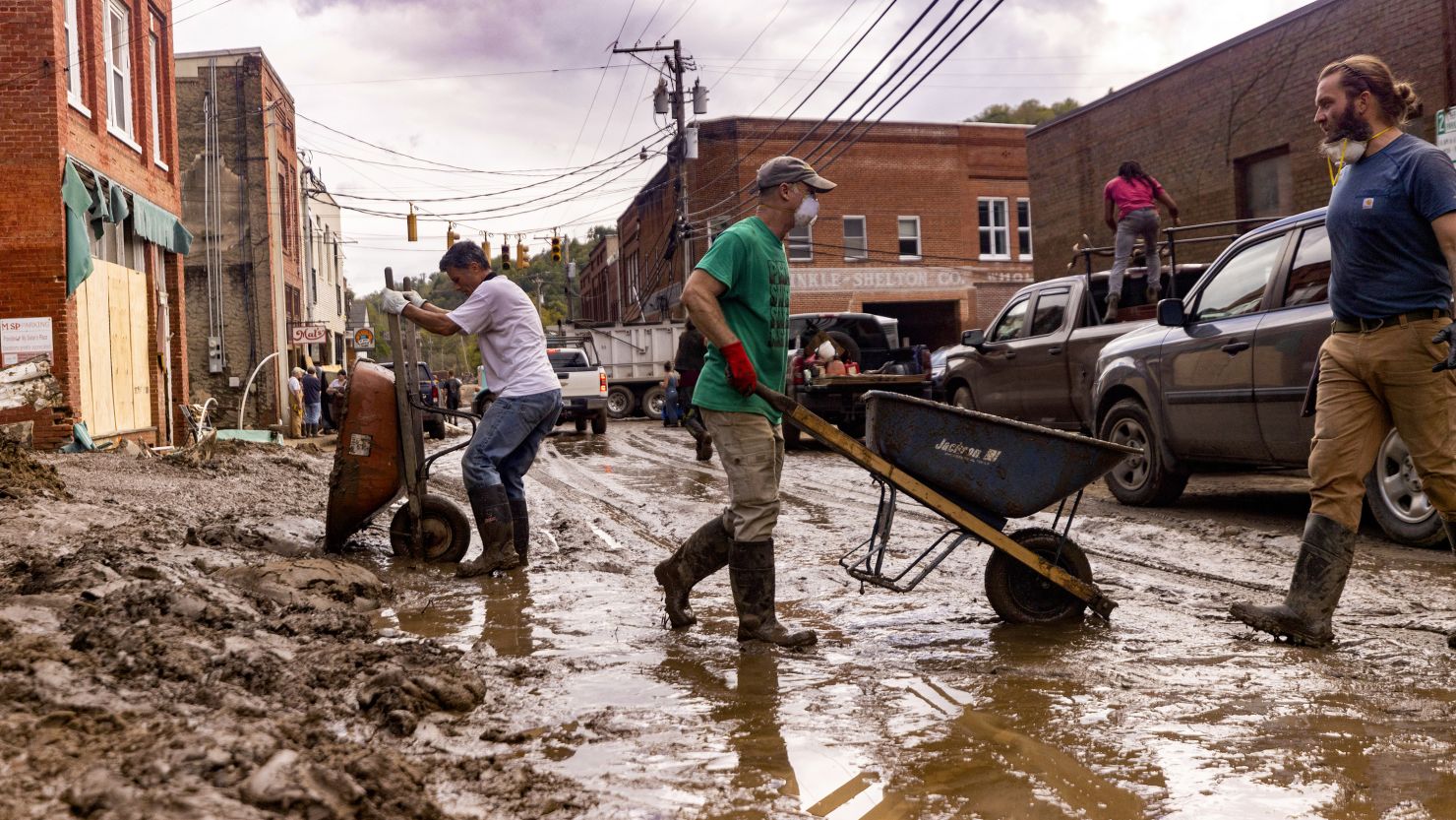 Residents and volunteers clean up on Tuesday, Oct. 1, 2024, after the French Broad River flooded downtown Marshall, North Carolina. The remnants of Hurricane Helene caused widespread flooding, downed trees, and power outages in western North Carolina. (Travis Long/The News & Observer/Tribune News Service via Getty Images)