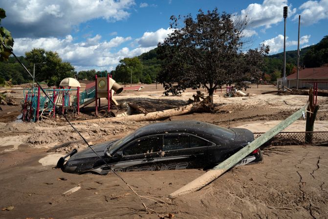 A police car is stuck in mud in a flooded area of Lake Lure, North Carolina, on Wednesday, October 2.