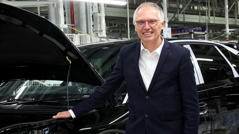 Stellantis CEO Carlos Tavares poses at the production line of the new Peugeot e-3008 and e-5008 electric car at the firm's factory in Sochaux, eastern France on October 3, 2024.