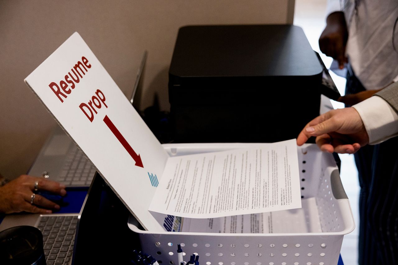 An attendee places their resume in a drop box at the Albany Job Fair in Latham, New York, US, on October 2.