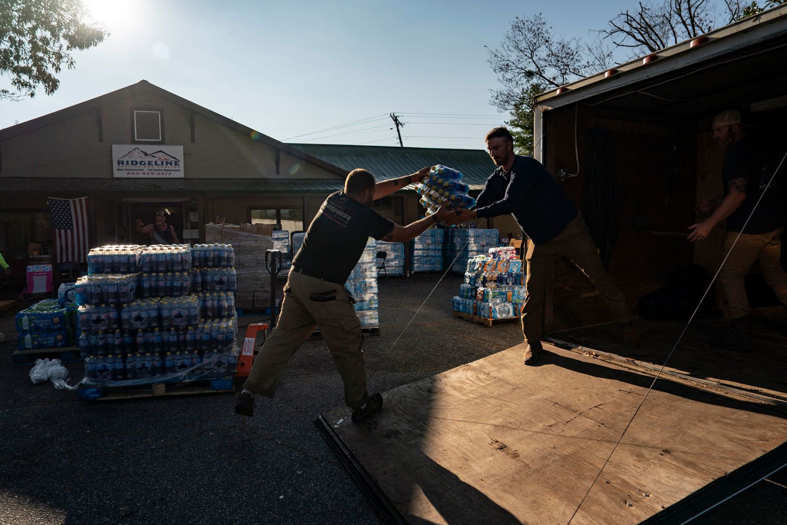 Volunteers load supplies at Ridgeline Heating and Cooling, which was turned into a relief area and community coordination center in Bills Creek, North Carolina, on Thursday.