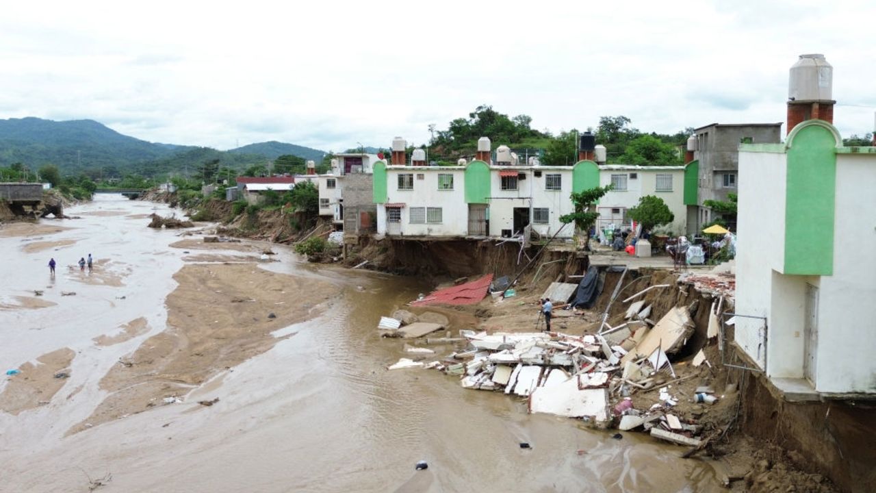 View of houses that collapsed due to the current of the stream that rose with the heavy rains following Hurricane John in Acapulco, Guerrero State, Mexico, on October 3, 2024. John made landfall last week as a Category 3 hurricane before churning along the coast for several days and striking land again as a tropical storm. (Photo by Francisco ROBLES / AFP) (Photo by FRANCISCO ROBLES/AFP via Getty Images)