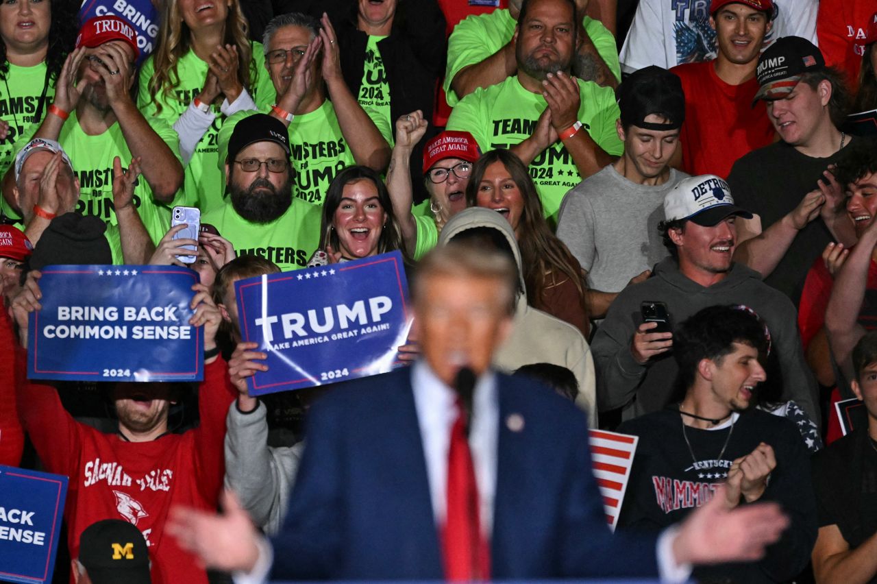 Supporters watch as former President Donald Trump speaks during a campaign rally in Saginaw, Michigan, on Thursday.