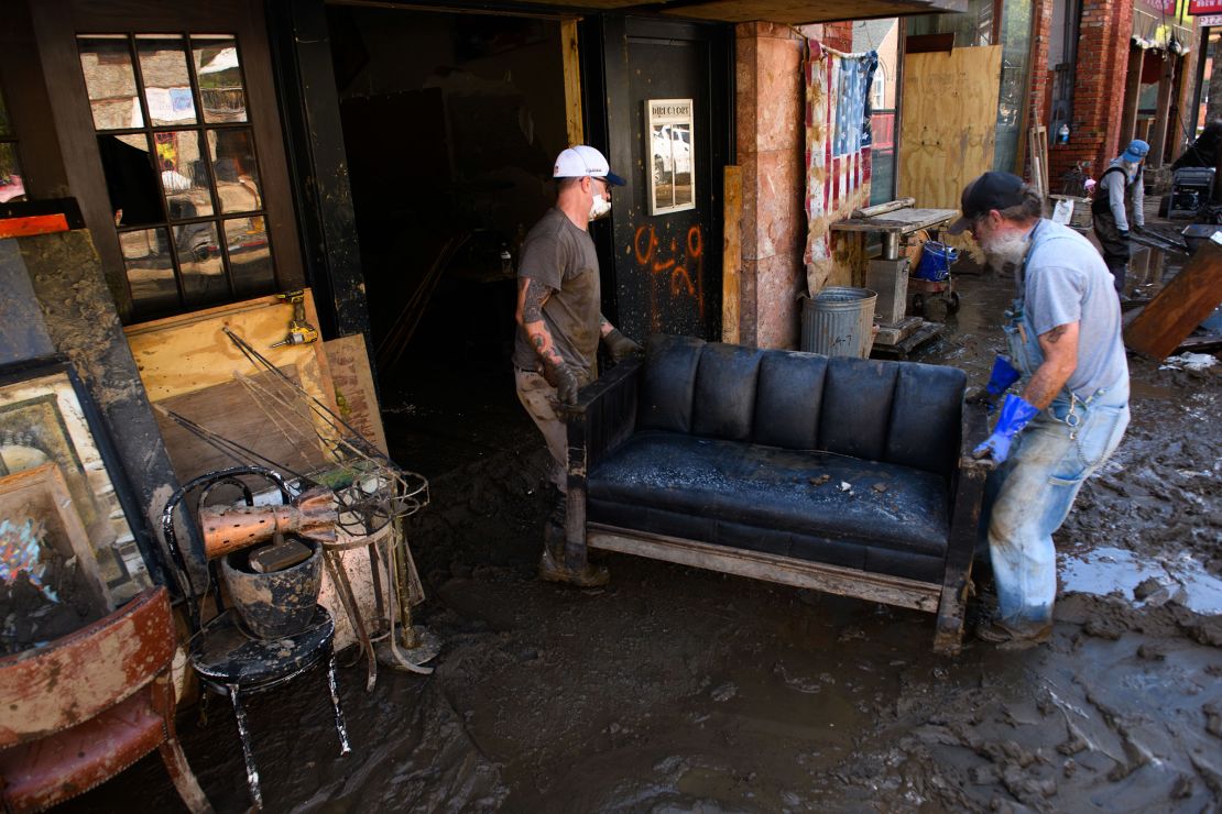 Men remove items from an art store in Marshall, North Carolina, on Thursday.