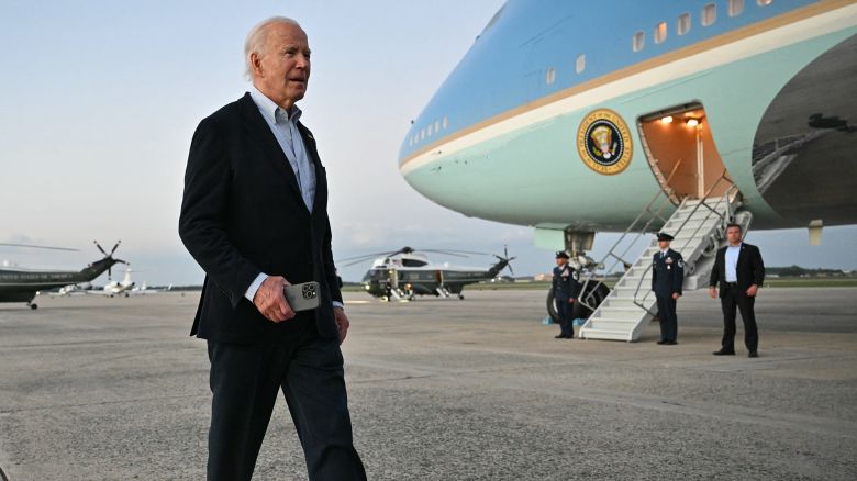US President Joe Biden walks to speak to reporters after stepping off Air Force One upon arrival at Joint Base Andrews in Maryland on October 3, 2024.