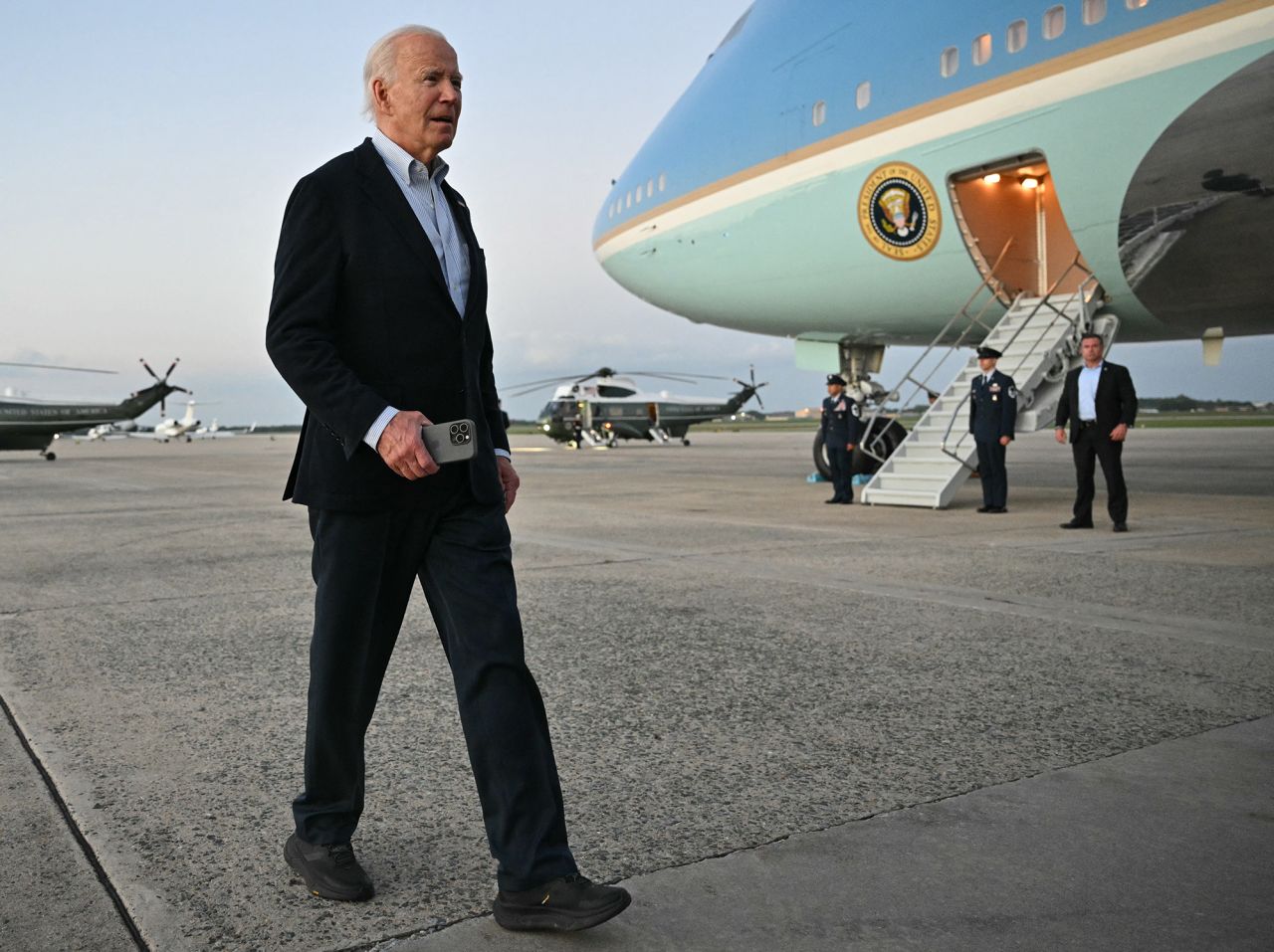 US President Joe Biden walks to speak to reporters after stepping off Air Force One upon arrival at Joint Base Andrews in Maryland on October 3.