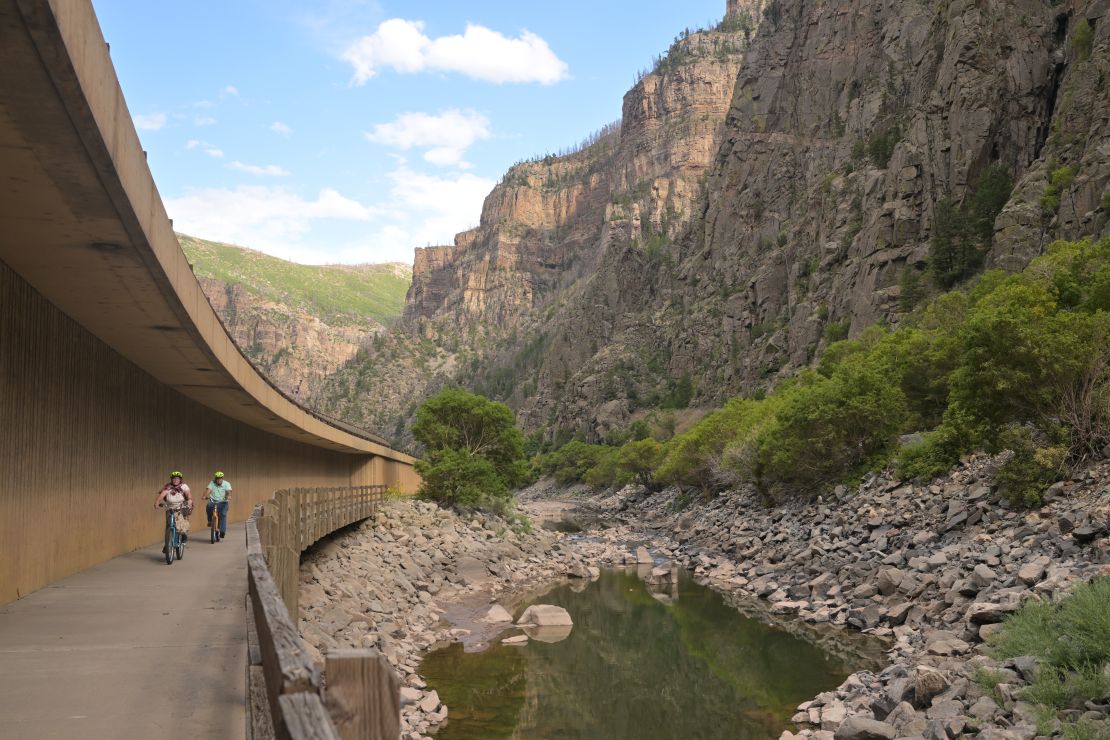 Bike riders pedal past a section of the Colorado River east of Glenwood Springs, Colorado, in September.