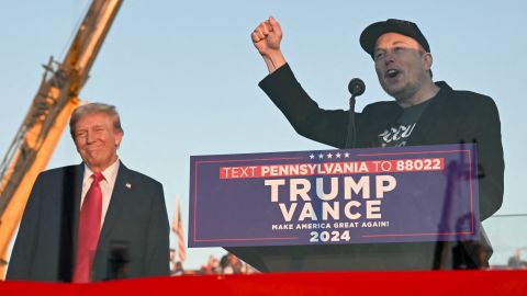 TOPSHOT - Tesla CEO Elon Musk (R) speaks on stage as he s former US President and Republican presidential candidate Donald Trump during a campaign rally at site of his first assassination attempt in Butler, Pennsylvania on October 5, 2024. (Photo by Jim WATSON / AFP) (Photo by JIM WATSON/AFP via Getty Images)