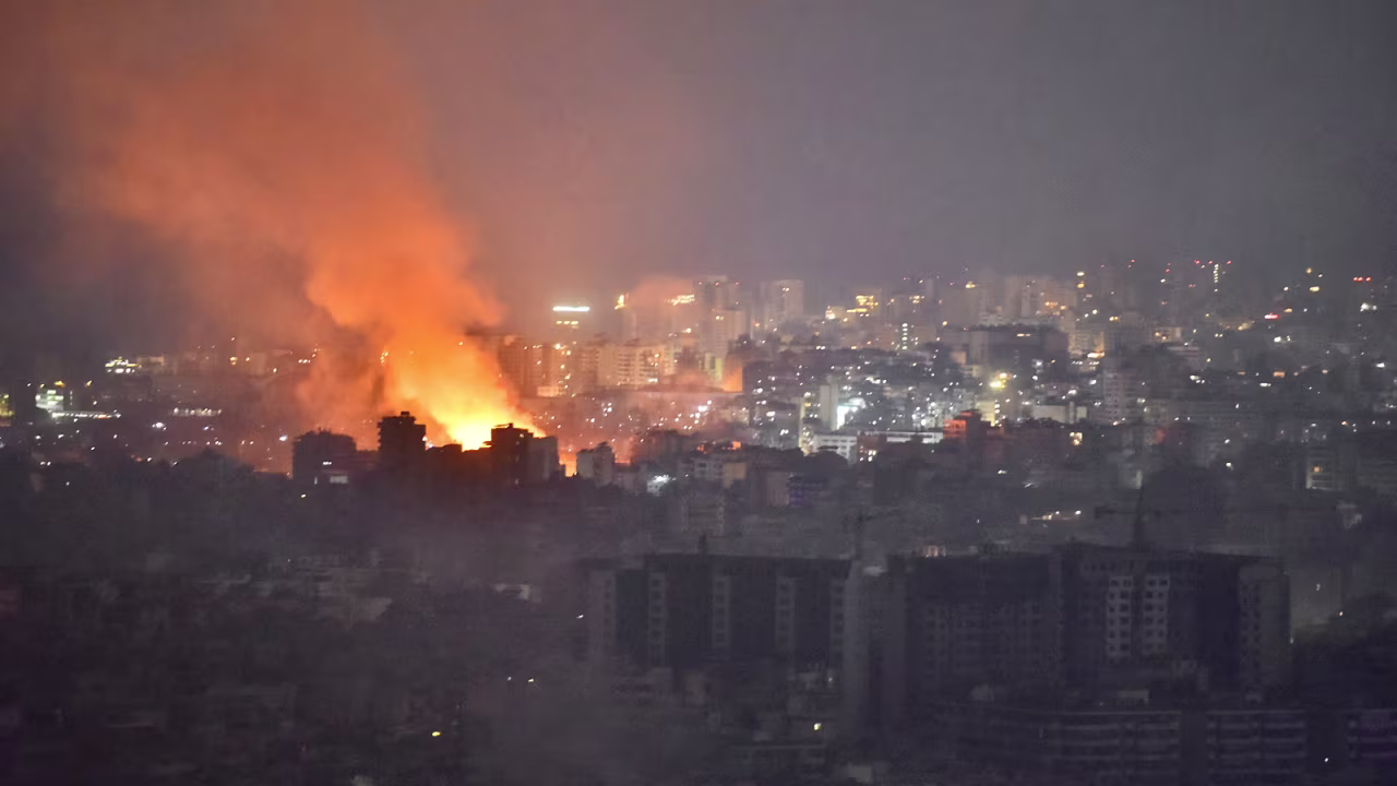 Flames and smoke rise in an area targeted by an Israeli air strike on Beirut's southern suburbs, on October 6.