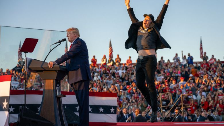 TOPSHOT - Tesla CEO Elon Musk (R) jumps on stage as he joins former US President and Republican presidential candidate Donald Trump during a campaign rally at site of his first assassination attempt in Butler, Pennsylvania on October 5, 2024. (Photo by Jim WATSON / AFP) (Photo by JIM WATSON/AFP via Getty Images)