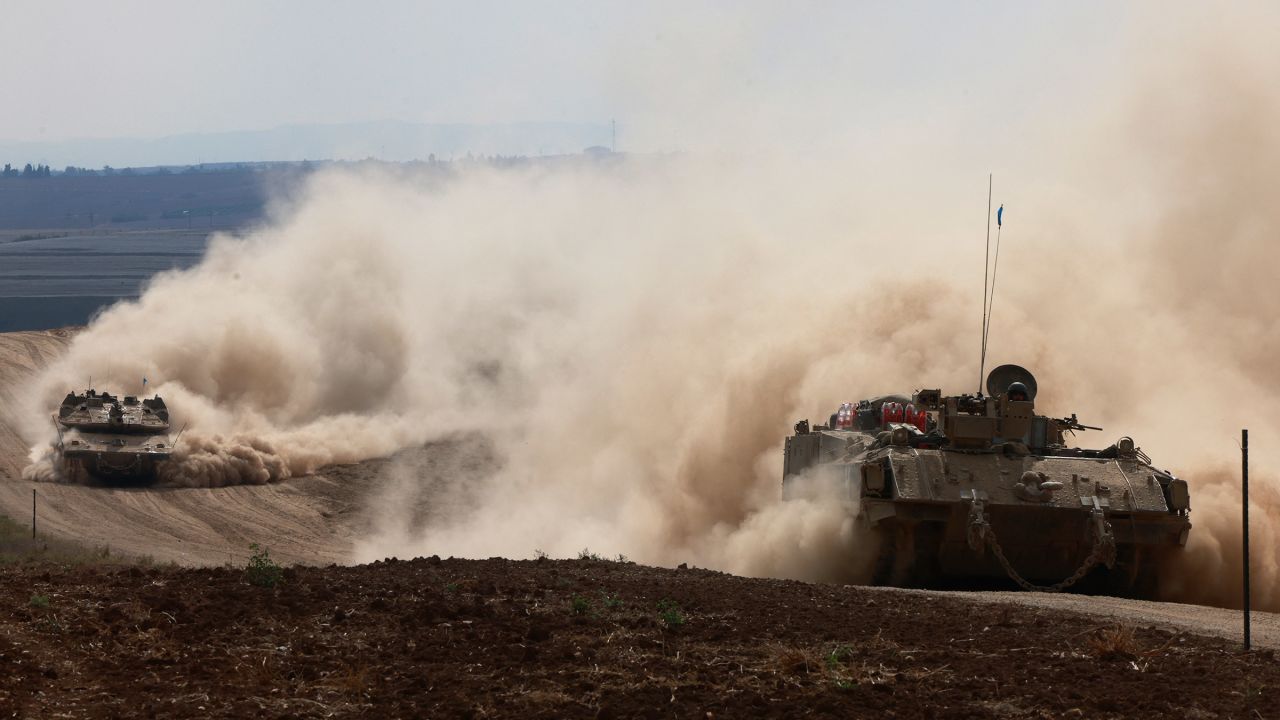 Israeli army tanks drive in an area near Israel's southern border with the Gaza Strip on October 6.