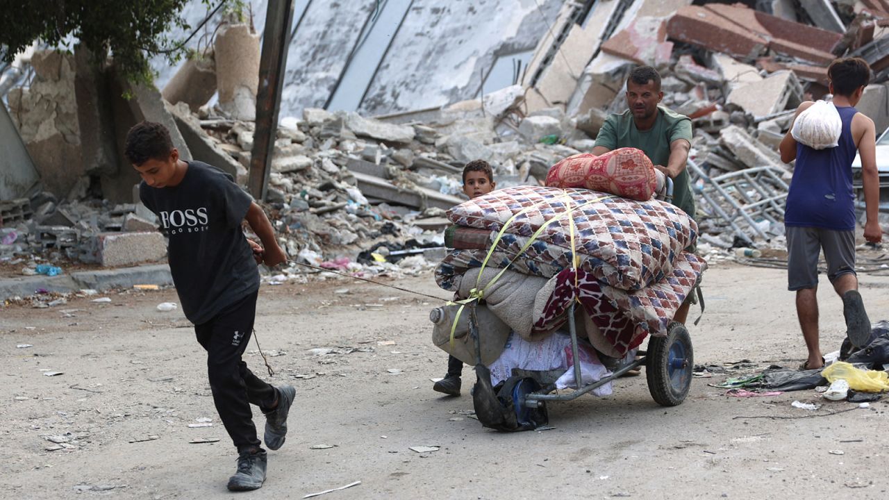 A Palestinian family arrives in Gaza City after evacuating their homes in the Jabalia area on October 6.