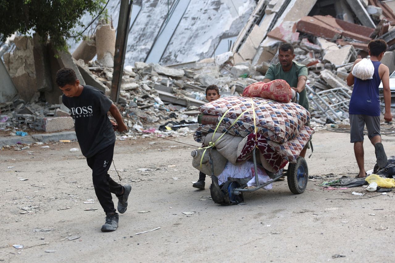 A Palestinian family arrives in Gaza City after evacuating their homes in the Jabalia area on October 6.