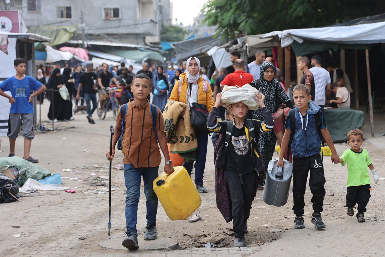 Palestinian families arrive in Gaza City after evacuating their homes in the Jabalia area on October 6, 2024, after the Israeli army ordered people to evacuate the area north of Gaza. The Israeli military said on October 6, its forces surrounded the Jabaliya area of northern Gaza in response to indications Hamas was rebuilding despite nearly a year of strikes and fighting. (Photo by Omar AL-QATTAA / AFP) (Photo by OMAR AL-QATTAA/AFP via Getty Images)