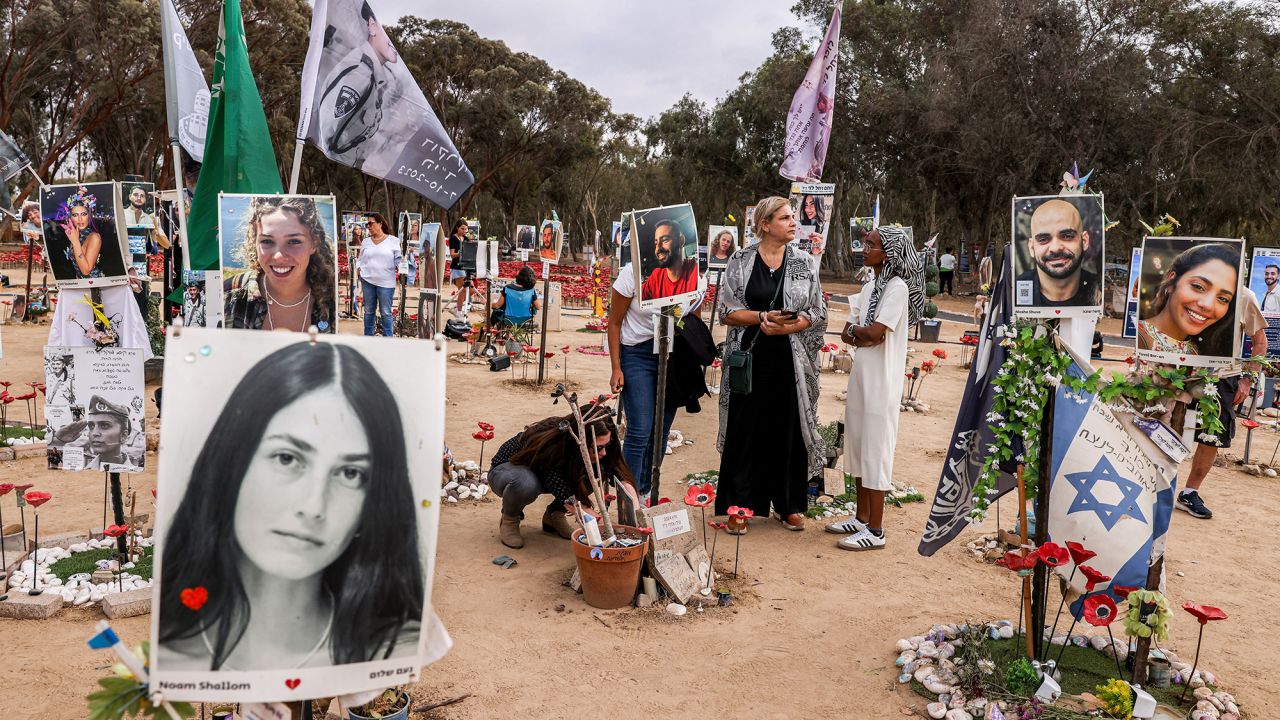 People visit a memorial for the victims killed at or kidnapped from the Supernova music festival during the October 7 attacks by Palestinian militants, at the festival site near Kibbutz Reim in southern Israel, on the eve of the attacks' first anniversary on October 6, 2024. (Photo by Menahem KAHANA / AFP) (Photo by MENAHEM KAHANA/AFP via Getty Images)