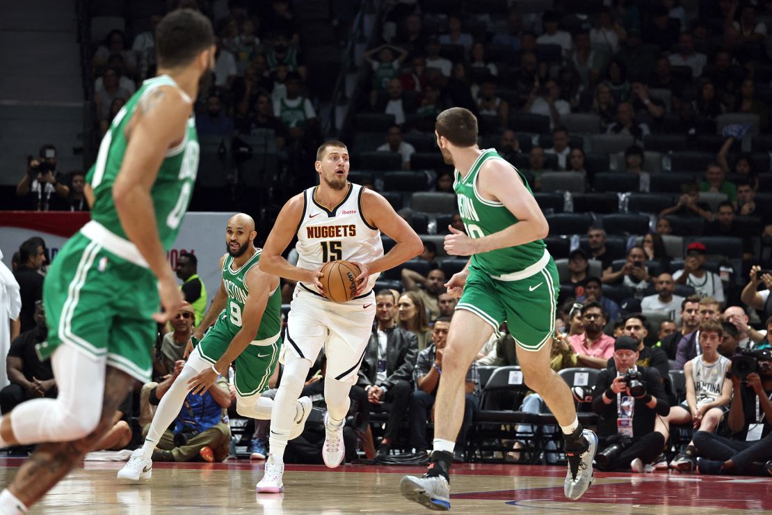 Jokić looks to pass in the NBA preseason game between the Nuggets and the Celtics.