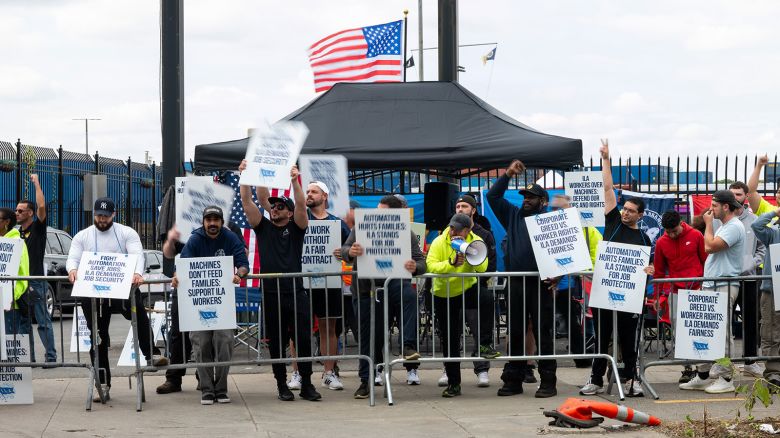 NEW YORK, NEW YORK - OCTOBER 02: Striking workers at the Red Hook Container Terminal in Brooklyn gather after members of the International Longshoremen’s Association, or ILA, began walking off the job yesterday after 12:01 a.m. ET on October 02, 2024 in Brooklyn, New York. The strike of over 50,000 workers at ports along the East Coast and Texas comes after the just-expired master contract with the United States Maritime Alliance, or USMX. Workers are striking over wages, automation, and other issues. (Photo by Spencer Platt/Getty Images)