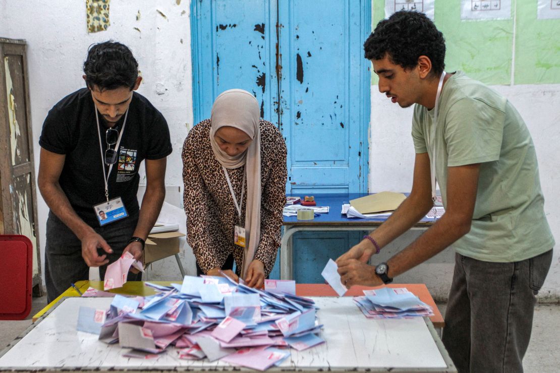 Officials of Tunisia's High Independent Authority for Elections (ISIE) count ballots after the end of voting in the 2024 presidential election at a polling station in Tunis on October 6, 2024.