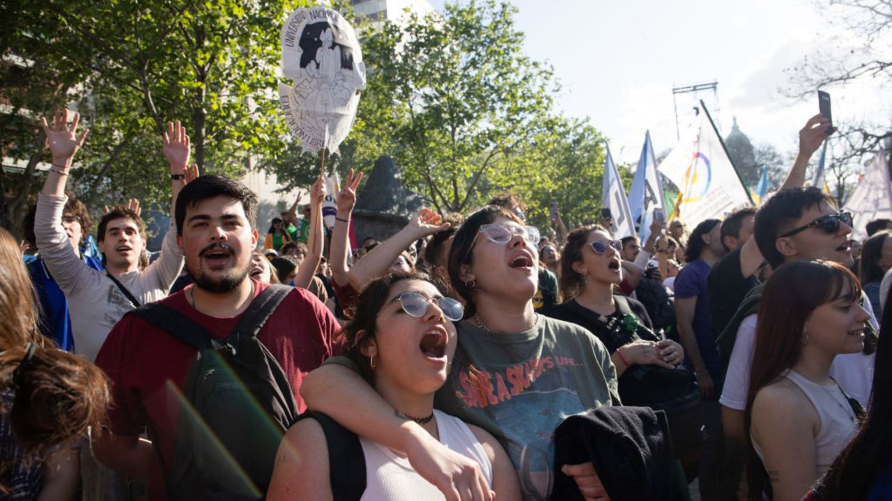 BUENOS AIRES, ARGENTINA - OCTOBER 02: Protesters sing the national anthem during the second nationwide demonstration against president Milei's budget-cuts to public universities on October 02, 2024 in Buenos Aires, Argentina. The march have been called by university authorities and students after the President of Argentina Javier Milei warned that he will veto a law that improves the budget of high education institutions. (Photo by Tobias Skarlovnik/Getty Images)