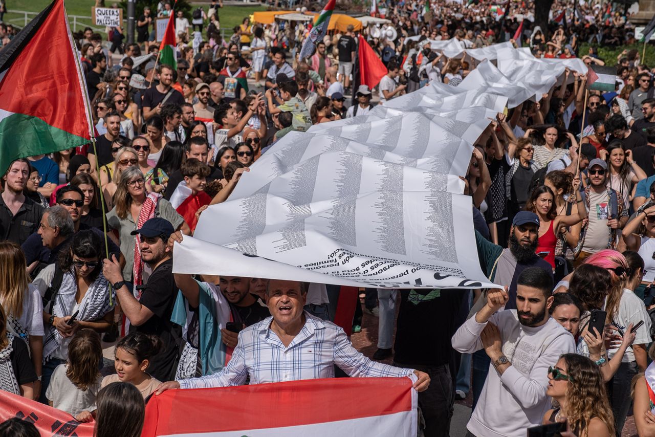 A long roll of paper containing the names of people killed in the Israeli occupation is seen carried by protesters in Plaza de Catalunya during the rally in Barcelona, Spain, on October 6.