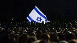 Members of the Australian Jewish community hold an Israeli flag during a memorial service in Sydney on October 7, 2024, to mark the anniversary of Palestinian militant group Hamas's October 7, 2023 attack on Israel. (Photo by DAVID GRAY / AFP) (Photo by DAVID GRAY/AFP via Getty Images)