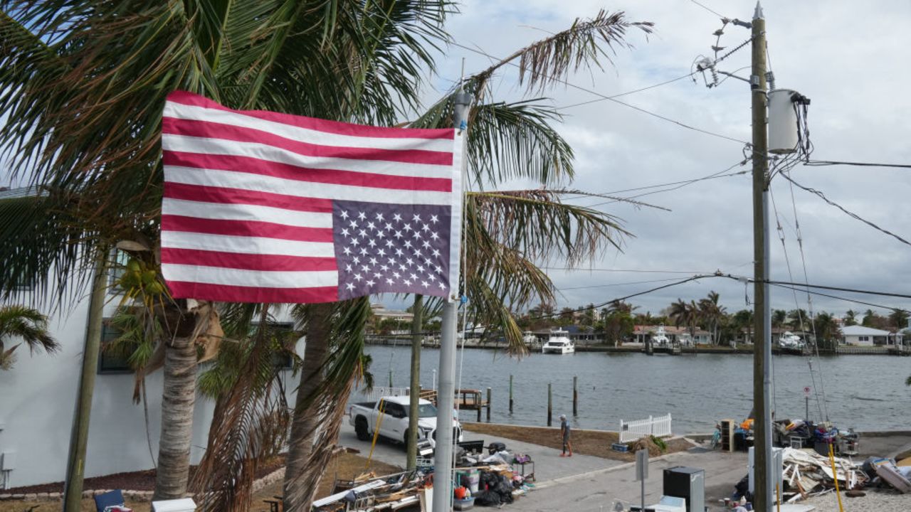 An American flag flies upside down, the international sign for distress, at a home ahead of Hurricane Milton's expected landfall in the middle of this week  in Treasure Island, Florida on October 7, 2024. Florida's governor has declared a state of emergency on Saturday as forecasters warned that Hurricane Milton is expected to make landfall later this week. (Photo by Bryan R. SMITH / AFP) (Photo by BRYAN R. SMITH/AFP via Getty Images)