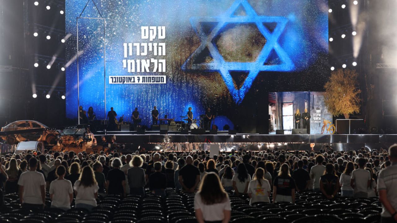 People observe a moment of silence during a memorial ceremony to mark the first anniversary of the October 7, 2023 attacks, in the Israeli coastal city of Tel Aviv on October 7, 2024. Israel marked the first anniversary of the deadliest attack in its history, with Prime Minister Benjamin Netanyahu saying the Gaza and Lebanon wars would ensure the violence it endured last October 7 could never be repeated. (Photo by Jack GUEZ / AFP) (Photo by JACK GUEZ/AFP via Getty Images)