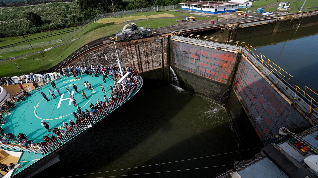 Tourists stand on deck as the cruise ship Brilliance of the Seas enters the Miraflores locks of the Panama Canal in Panama City on October 7, 2024. The 2024-2025 cruise season in Panama began Monday with the passage of the Brilliance of the Seas, which completes its 15-day itinerary between Los Angeles and New Orleans. (Photo by MARTIN BERNETTI / AFP) (Photo by MARTIN BERNETTI/AFP via Getty Images)