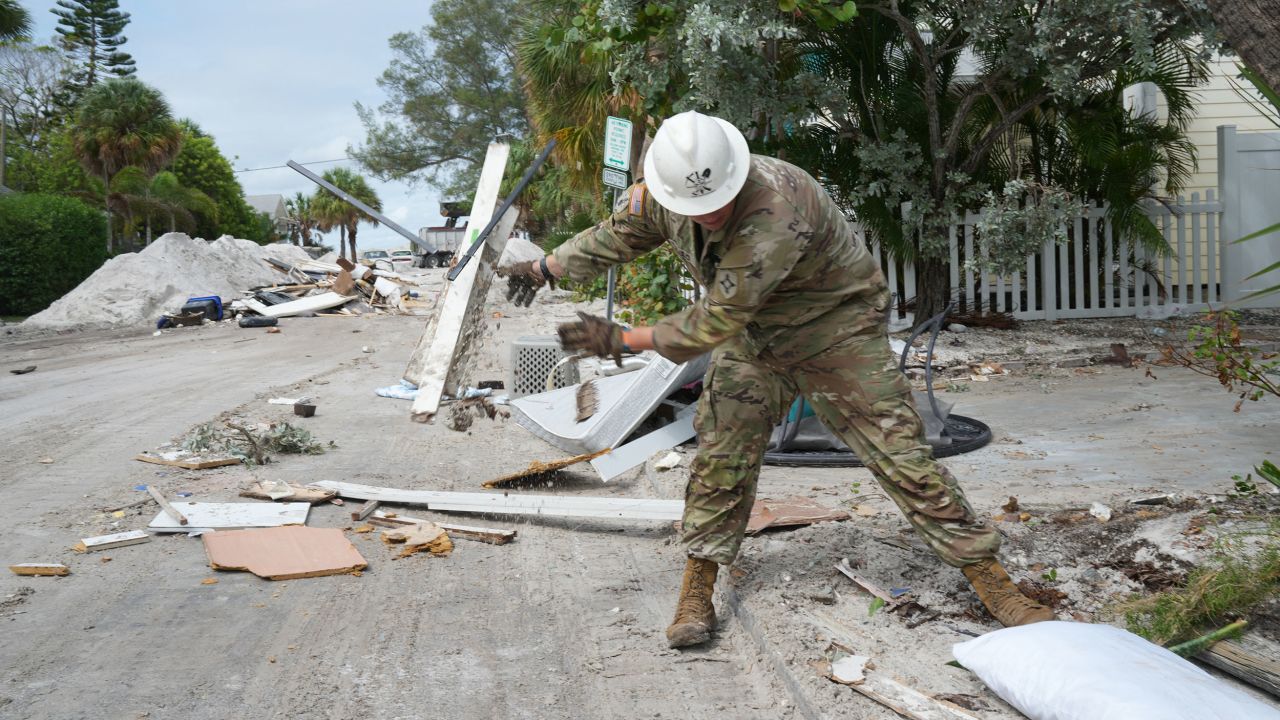 A Florida Army National Guard member works to remove debris in the Pass-A-Grille section of St. Petersburg ahead of Hurricane Milton's expected landfall in the middle of this week on October 7.